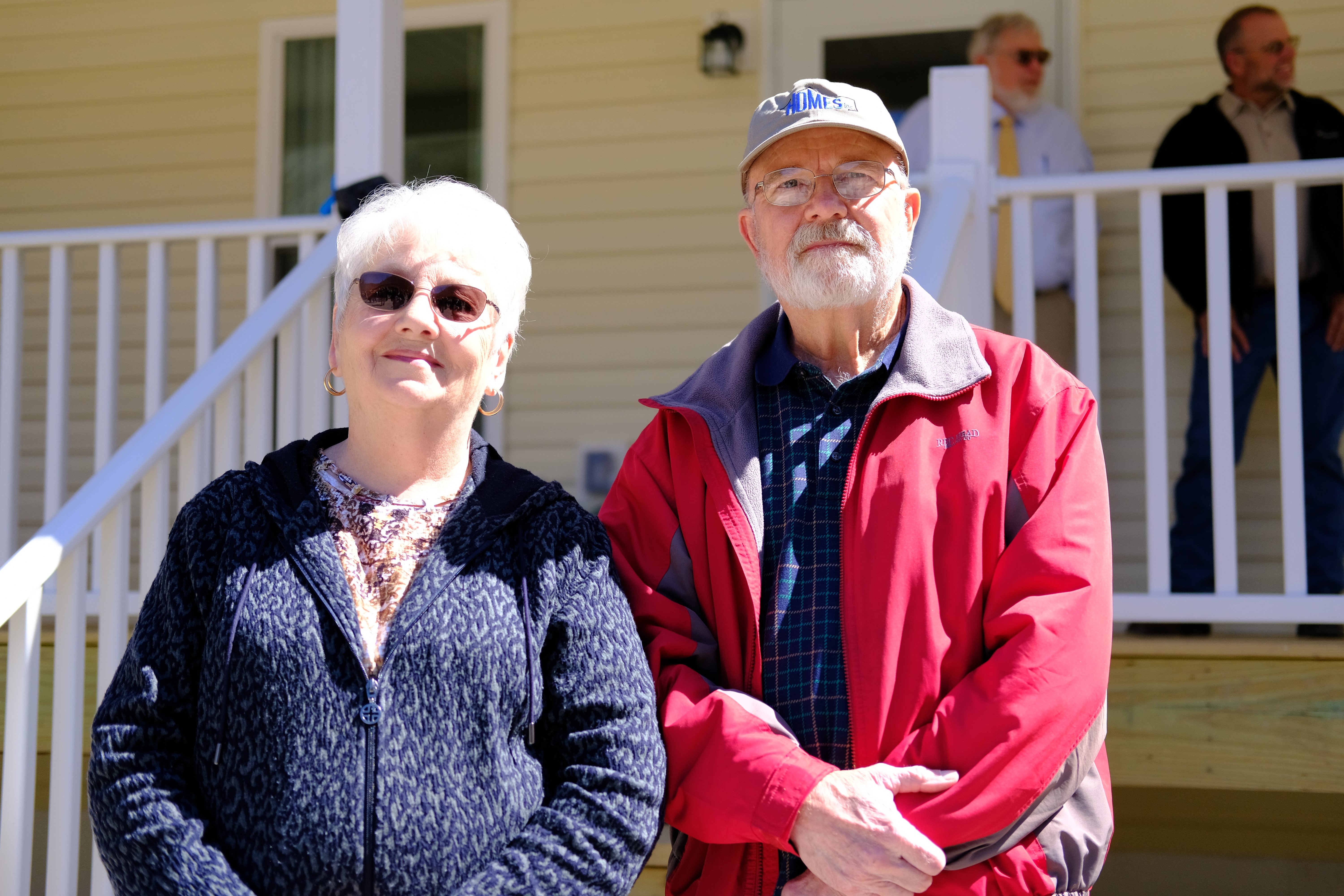 Faye and Arnold Weaver in front of their HOMES house