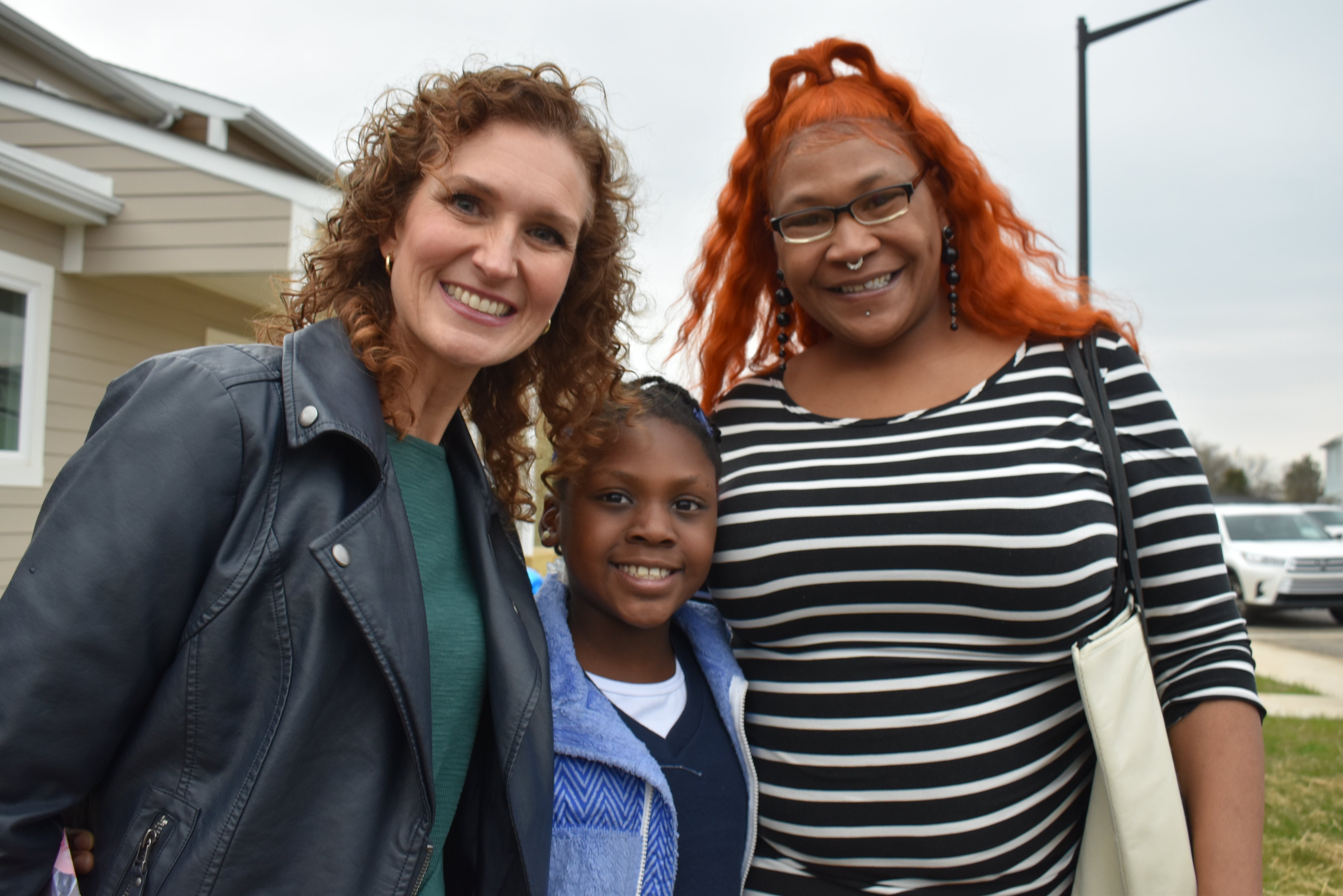 KHC's Keli Reynolds poses with new homeowners