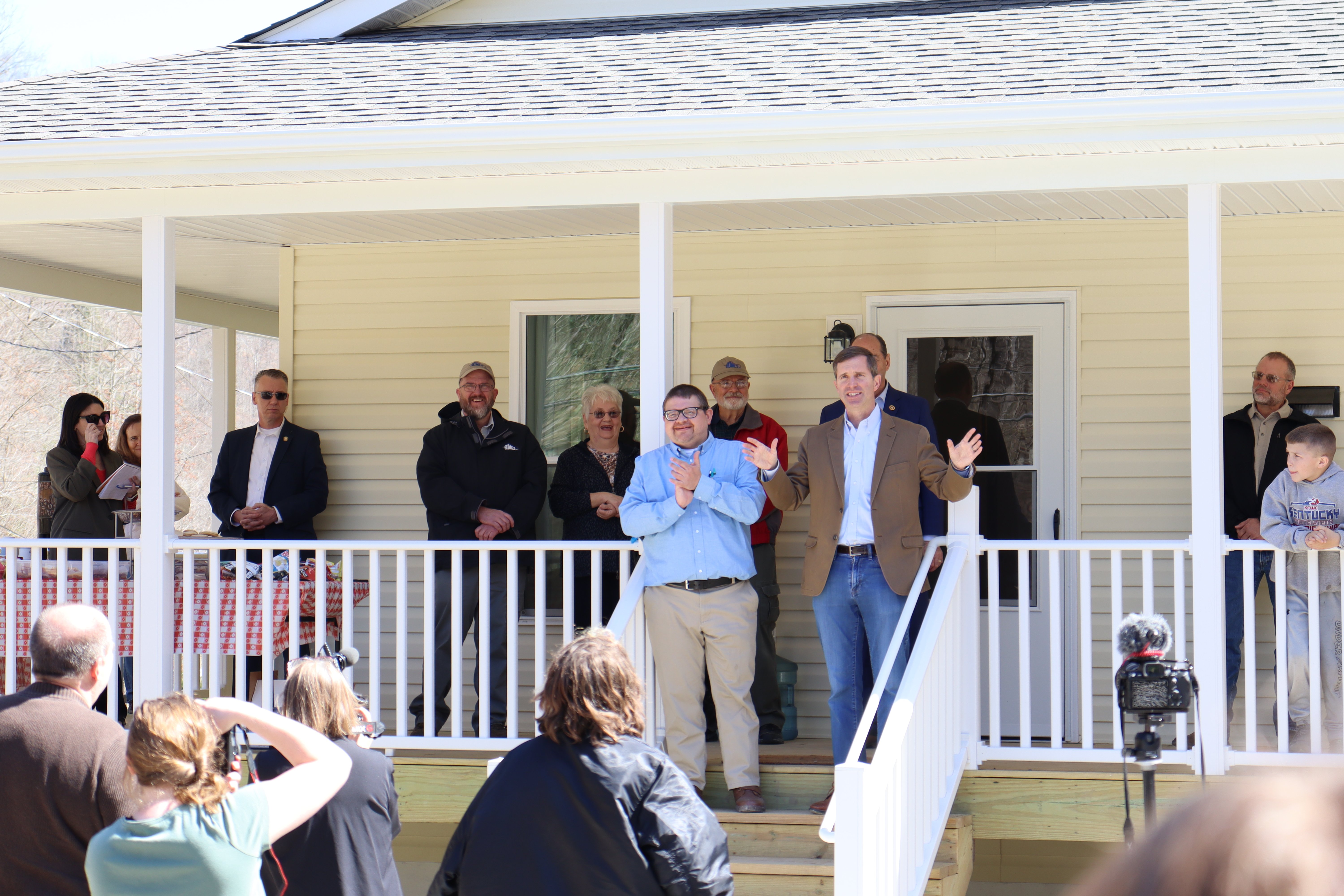 Governor Beshear and Jason Gross speak to the crowd