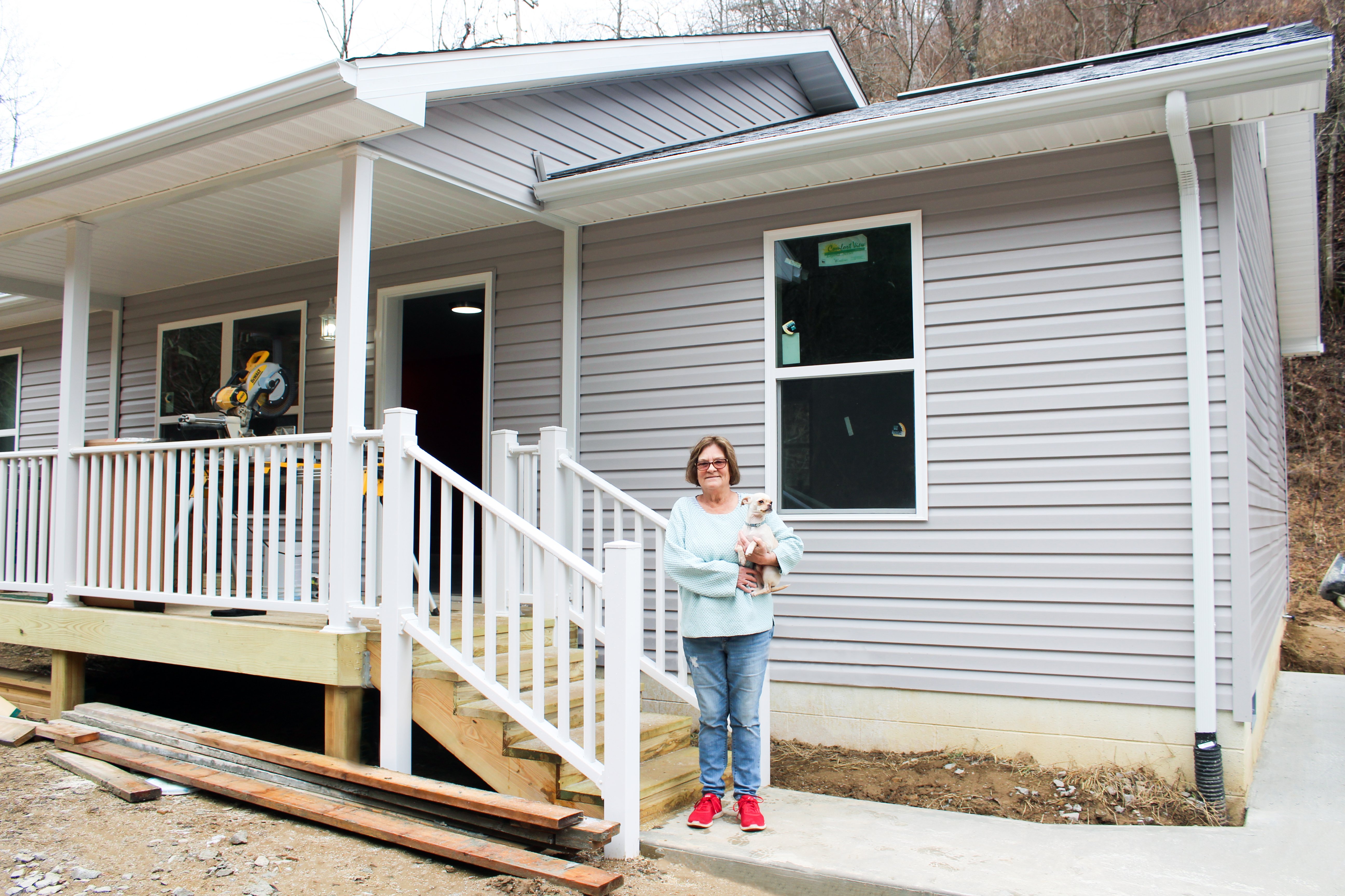 Terry with her dog Ghost in front of her HDA house