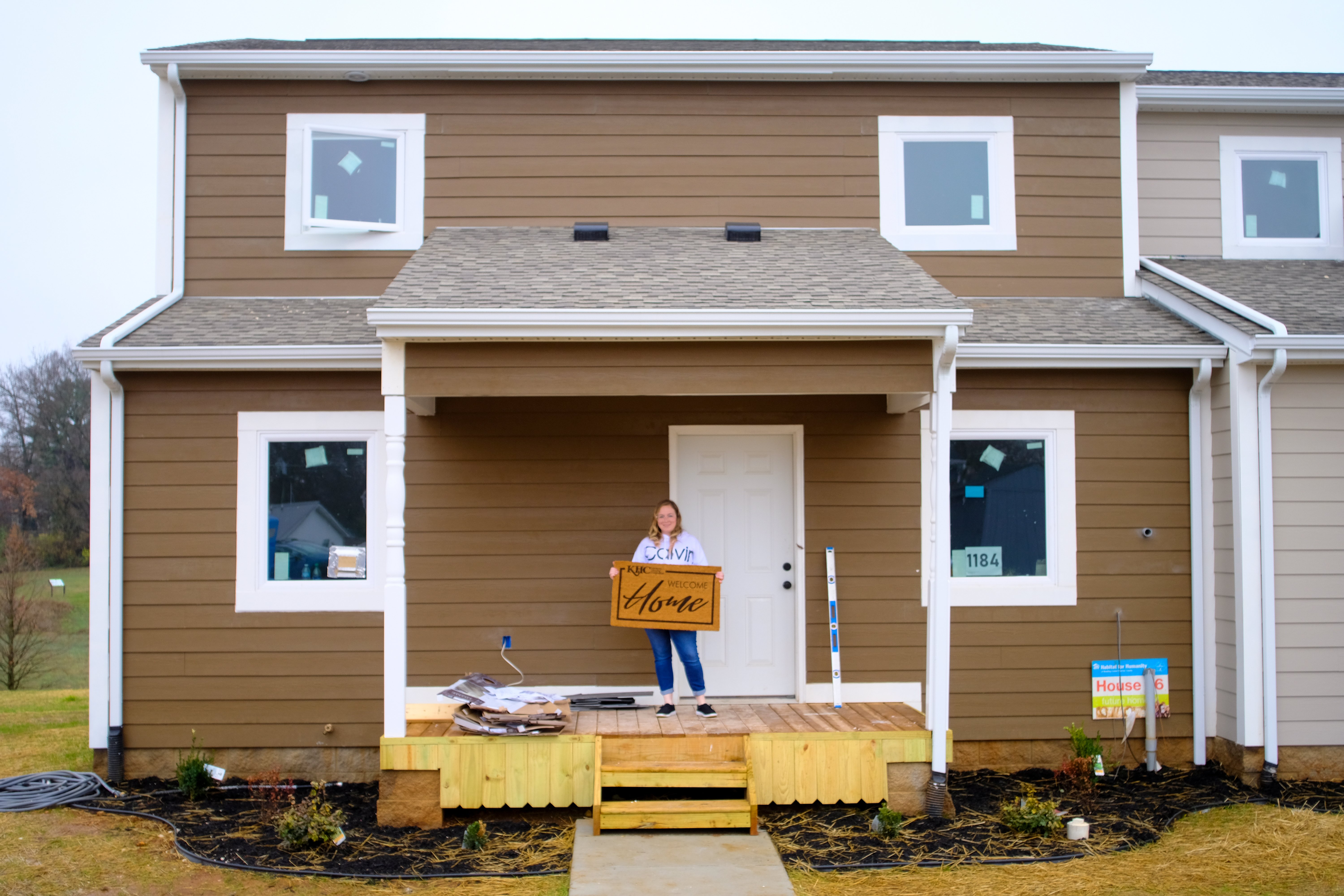 Ashley on the porch of her new Habitat home