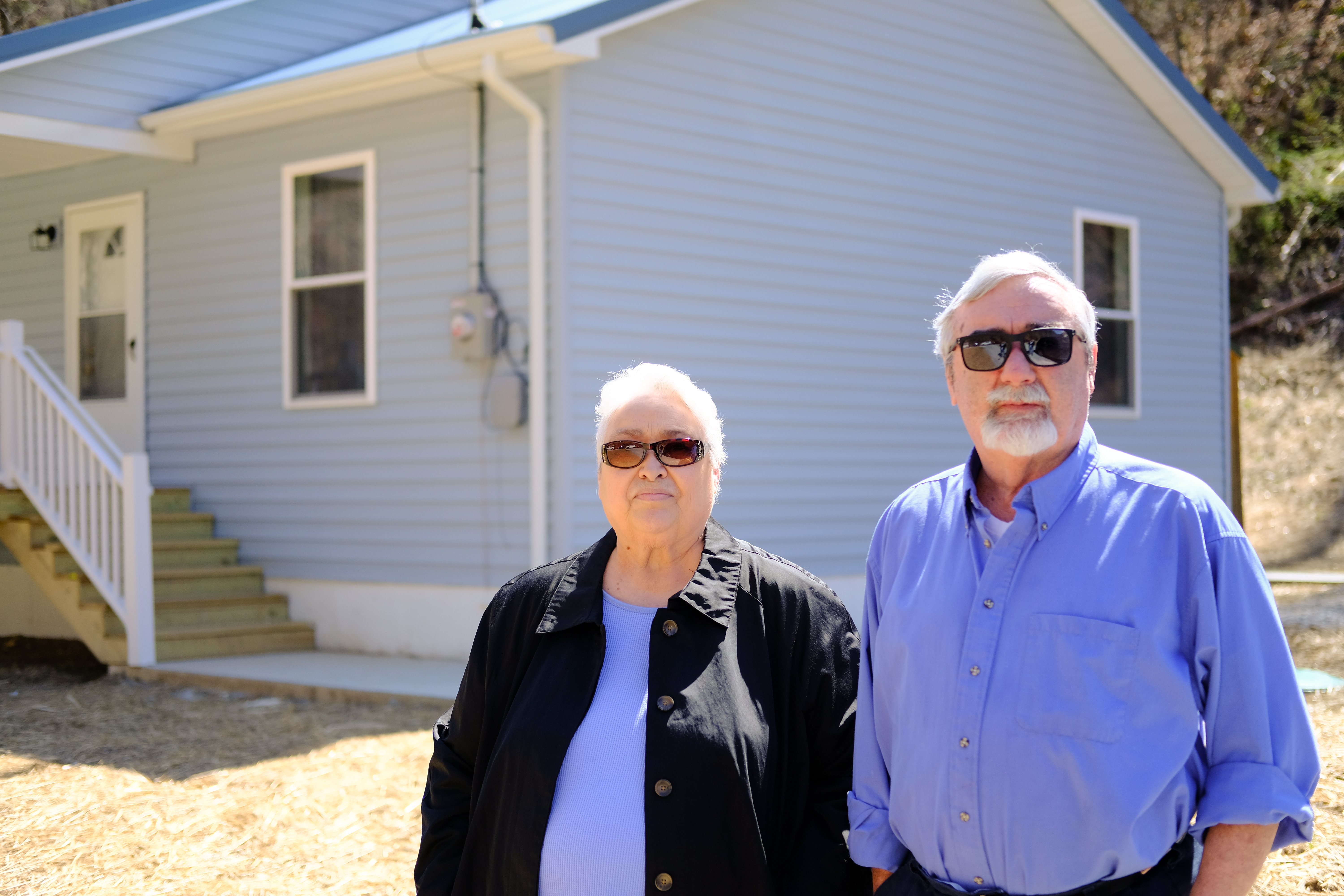 Terry and Brenda Morgan in front of their HOMES house